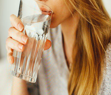Photo of woman drinking water from glass