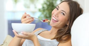 Prebiotic woman eating cereal and prebiotics